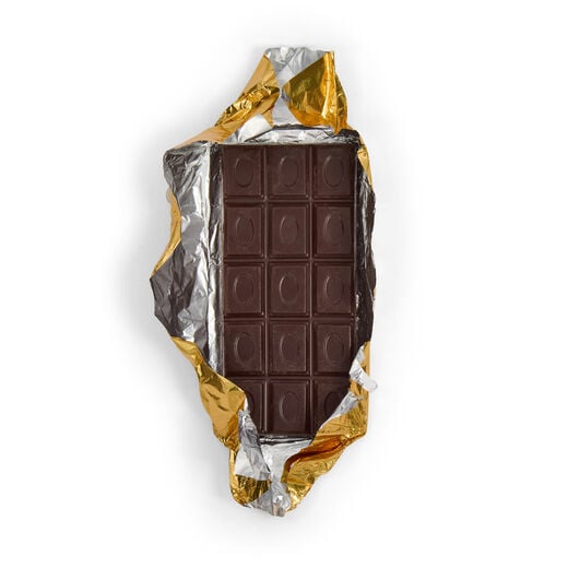A dark chocolate bar wrapped in a gold foil and paper.